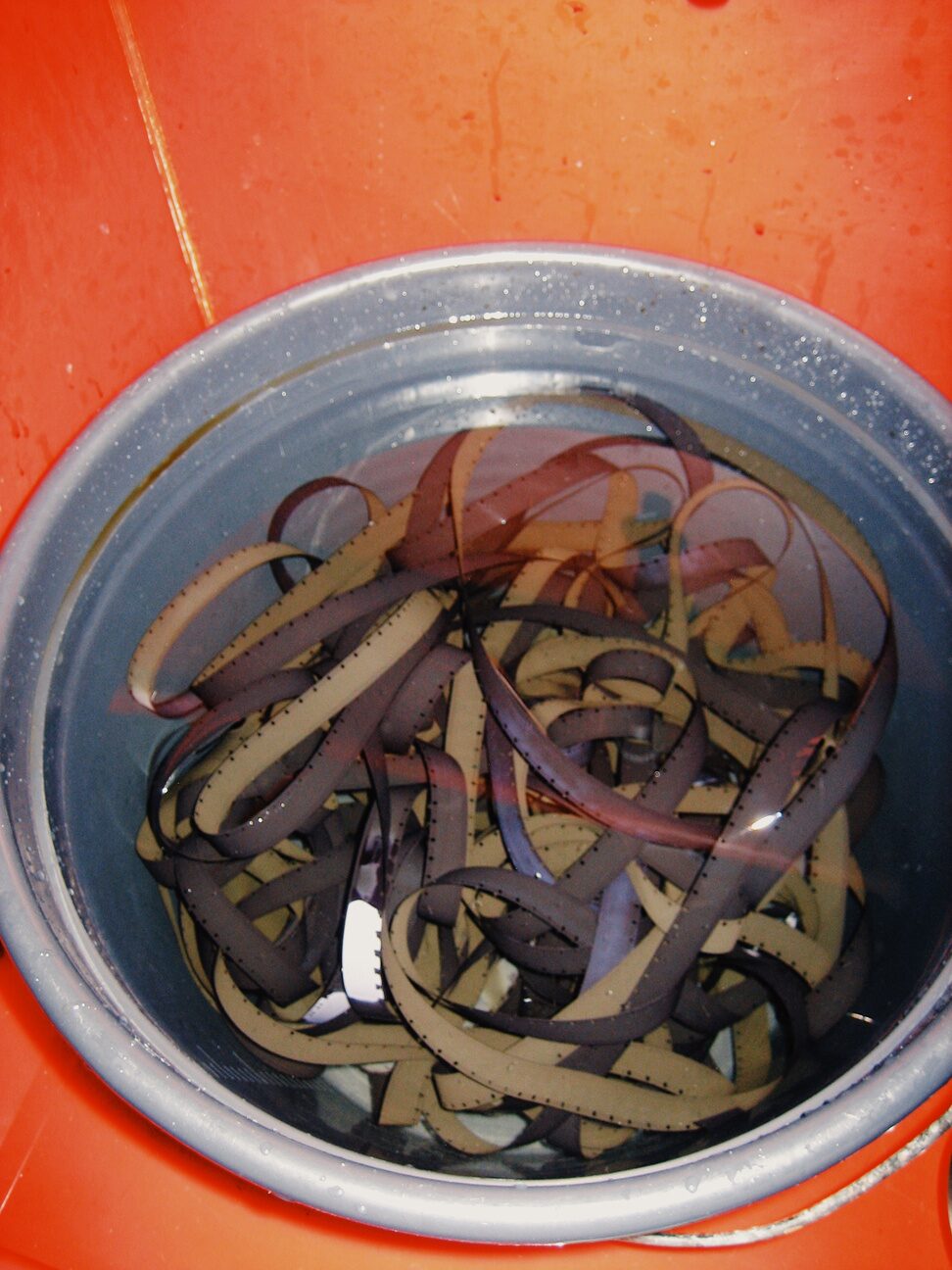 Loops of developed film resting in a metal bowl