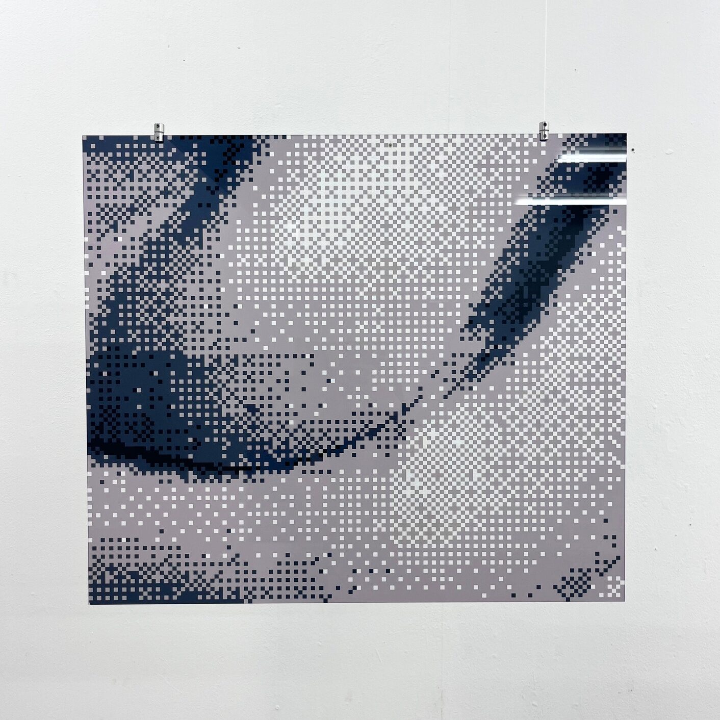 Pixelated monochrome fragment of a body printed as a square photograph