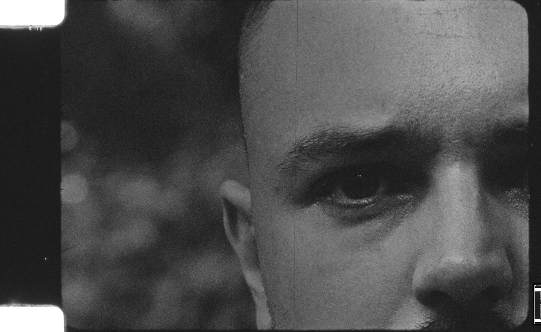 Close black-and-white portrait of a young man's face