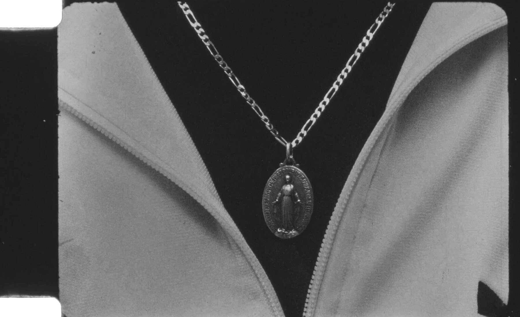 Black-and-white close-up of a pendant and chain
