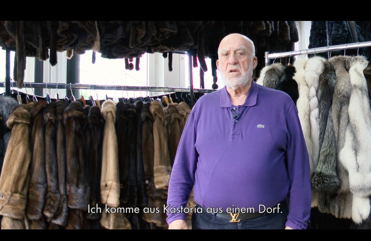 Older man standing in a fur shop